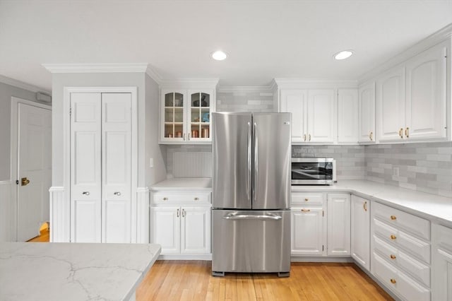 1051 Randolph Ave, Milton, MA 02186 - kitchen featuring stainless steel appliances, ornamental molding, white cabinets, glass insert cabinets, and backsplash