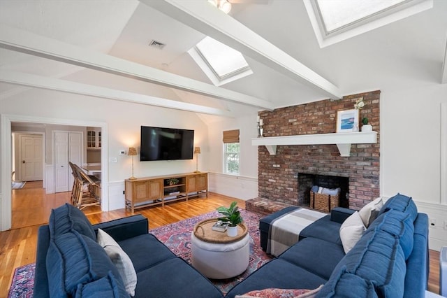 1051 Randolph Ave, Milton, MA 02186 - living area with a skylight, wood finished floors, and a brick fireplace
