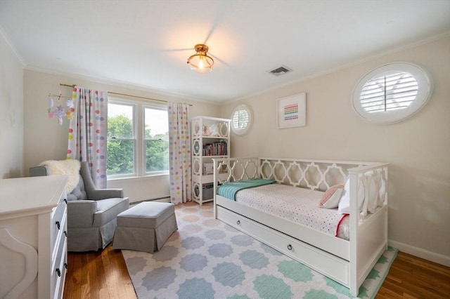 1051 Randolph Ave, Milton, MA 02186 - bedroom featuring crown molding, baseboard heating, wood finished floors, and baseboards