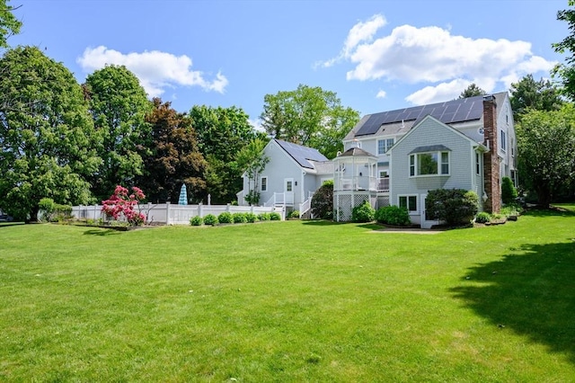 1051 Randolph Ave, Milton, MA 02186 - rear view of property with solar panels, stairs, and a deck