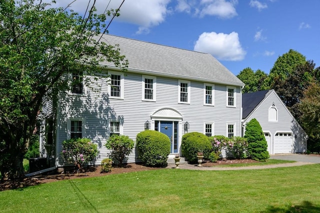 1051 Randolph Ave, Milton, MA 02186 - colonial home with a front yard, driveway, a garage, and an outbuilding