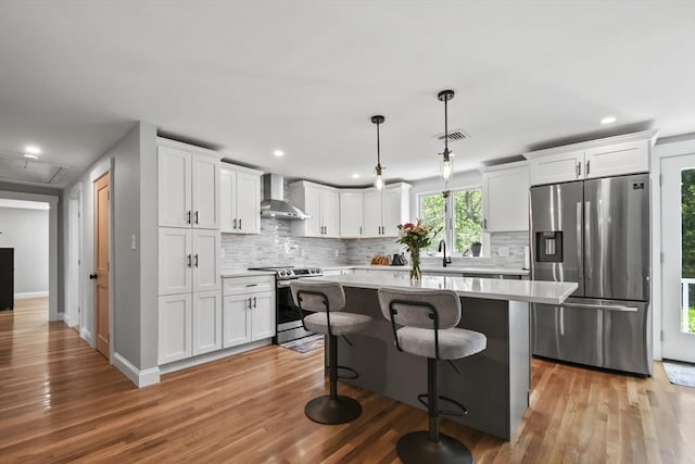 8 Longbow Cir, Lynnfield, MA 01940 - kitchen featuring appliances with stainless steel finishes, wall chimney exhaust hood, decorative backsplash, light countertops, and white cabinetry