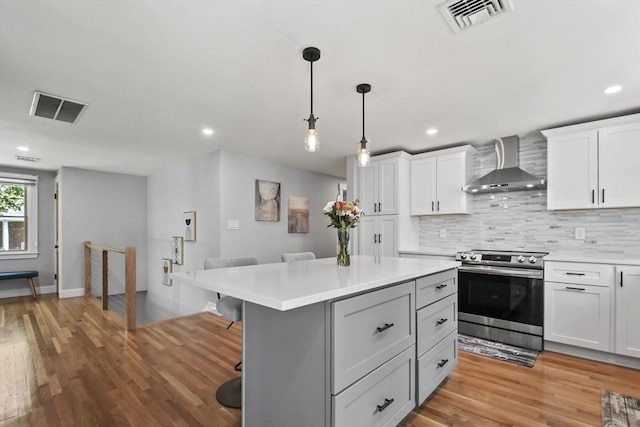 8 Longbow Cir, Lynnfield, MA 01940 - kitchen with wall chimney range hood, stainless steel range with electric stovetop, light countertops, backsplash, and recessed lighting