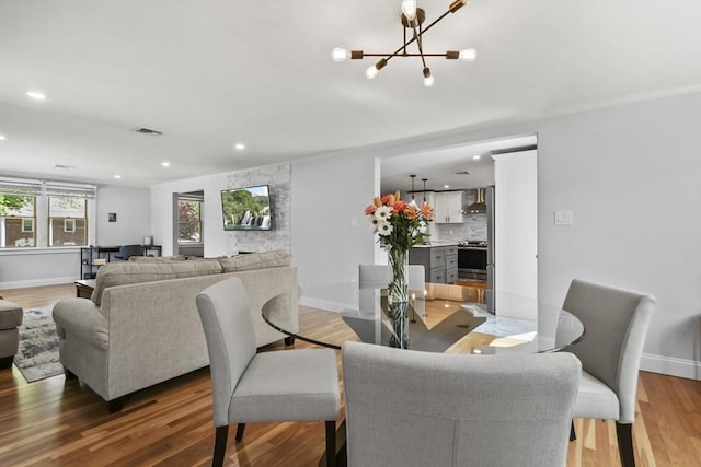 8 Longbow Cir, Lynnfield, MA 01940 - dining area featuring a chandelier, wood finished floors, baseboards, recessed lighting, and ornamental molding