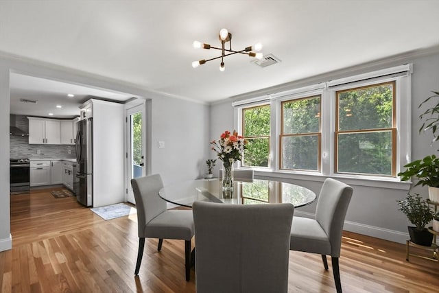 8 Longbow Cir, Lynnfield, MA 01940 - dining space with a chandelier, light wood-style flooring, crown molding, and baseboards