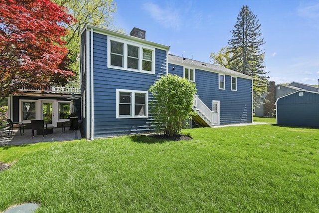 8 Longbow Cir, Lynnfield, MA 01940 - back of property with a chimney, a patio area, a yard, and stairway