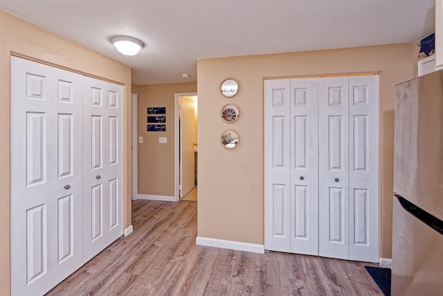 hall featuring baseboards and wood finished floors