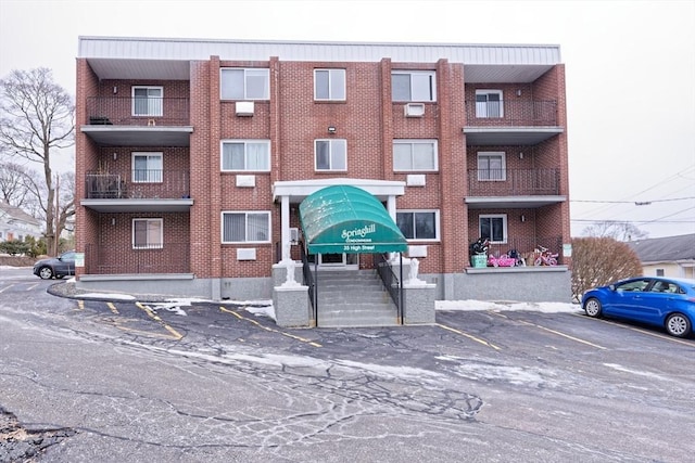 view of building exterior with uncovered parking