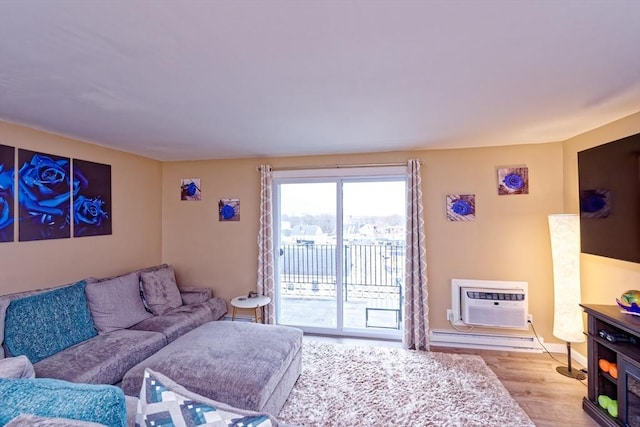 living area featuring a baseboard radiator, wood finished floors, and a wall mounted AC