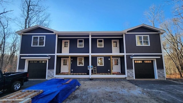 view of front facade with a garage and covered porch