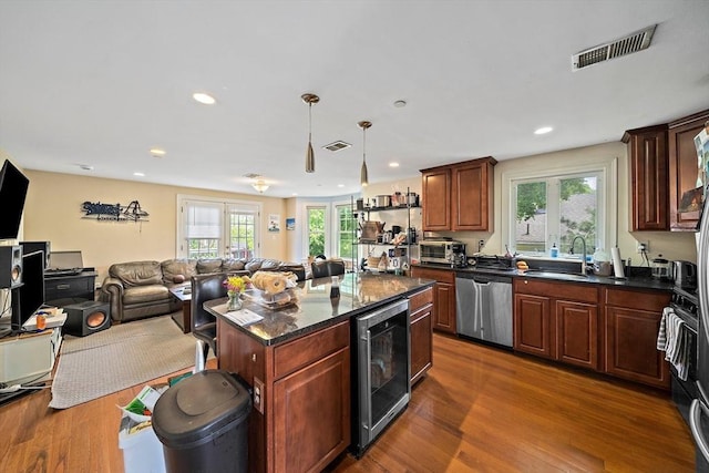 kitchen with wine cooler, stainless steel dishwasher, a sink, open floor plan, and dark wood-style flooring
