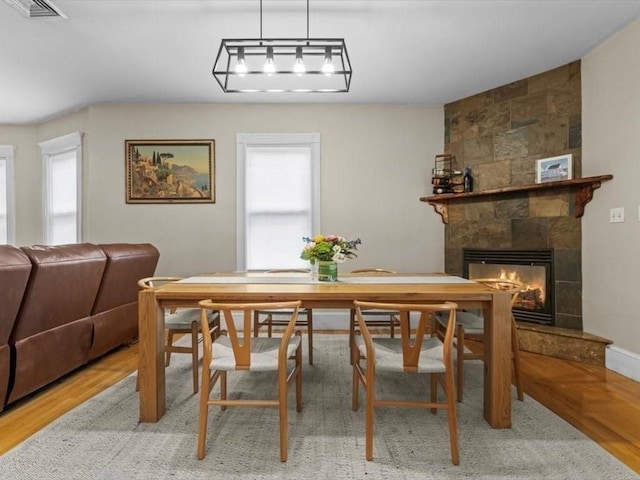 29 Chelmsford St Unit 2, Boston, MA 02122 - dining room featuring healthy amount of natural light, a tiled fireplace, and wood finished floors