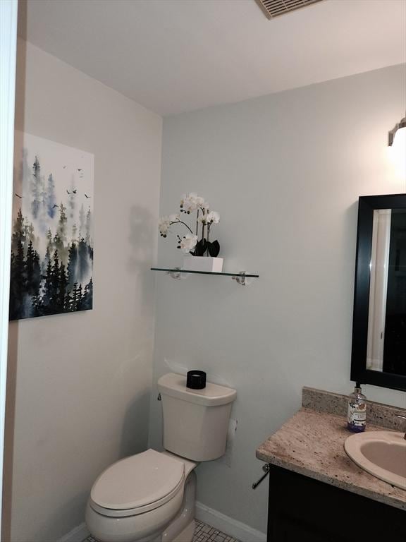 37 Mountain Gate Rd Unit 37, Ashland, MA 01721 - bathroom with baseboards, toilet, vanity, and tile patterned floors
