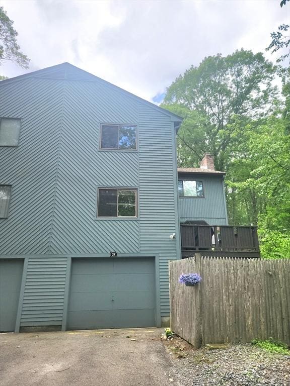 37 Mountain Gate Rd Unit 37, Ashland, MA 01721 - rear view of property with a garage, asphalt driveway, and a chimney