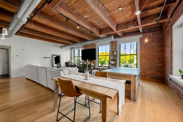 dining room with light hardwood / wood-style flooring, beamed ceiling, brick wall, and wood ceiling