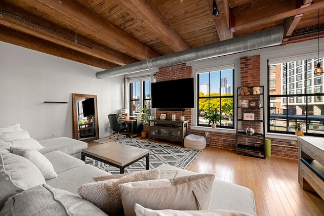 living room featuring beam ceiling, brick wall, hardwood / wood-style floors, and wooden ceiling