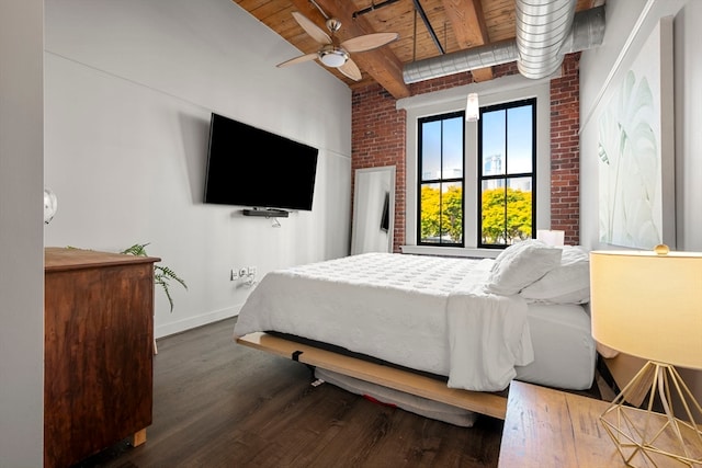 bedroom featuring wood ceiling, ceiling fan, beamed ceiling, dark wood-type flooring, and brick wall