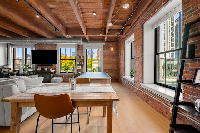 sunroom featuring wood ceiling, a healthy amount of sunlight, and beamed ceiling