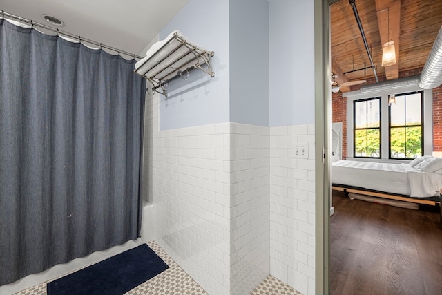 bathroom with brick wall, hardwood / wood-style flooring, wooden ceiling, and tile walls