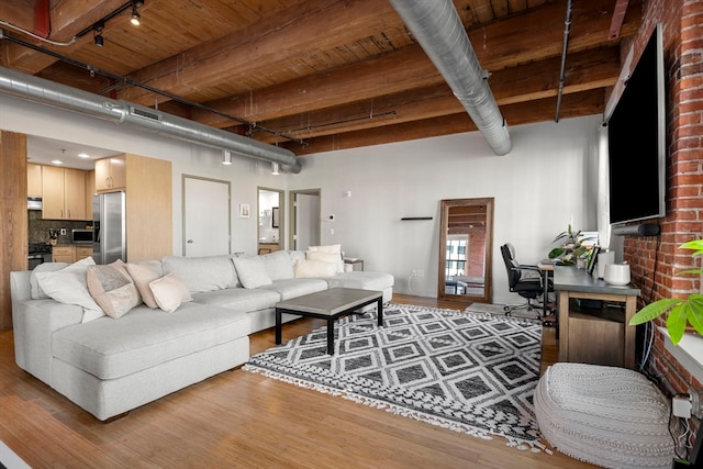 living room with rail lighting, beam ceiling, wood ceiling, and hardwood / wood-style floors