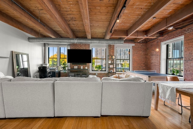 living room with wood ceiling, track lighting, light hardwood / wood-style flooring, beamed ceiling, and brick wall