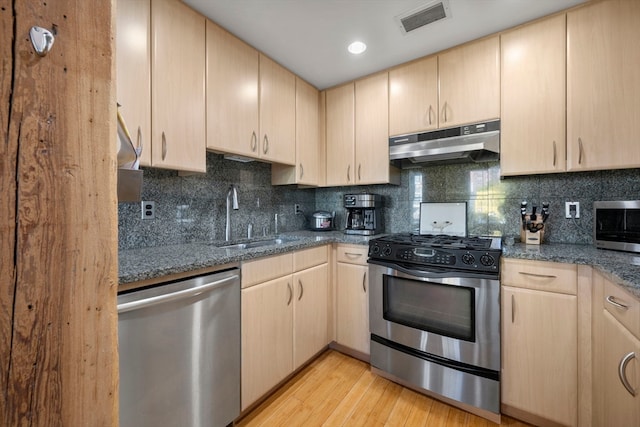 kitchen with light hardwood / wood-style flooring, light brown cabinets, and stainless steel appliances