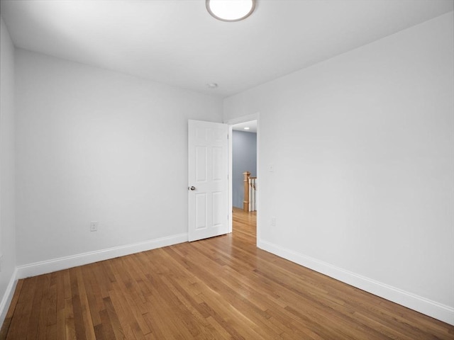 unfurnished room featuring light wood-style flooring and baseboards