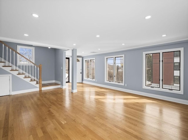 unfurnished living room featuring stairway, recessed lighting, light wood-style flooring, and baseboards