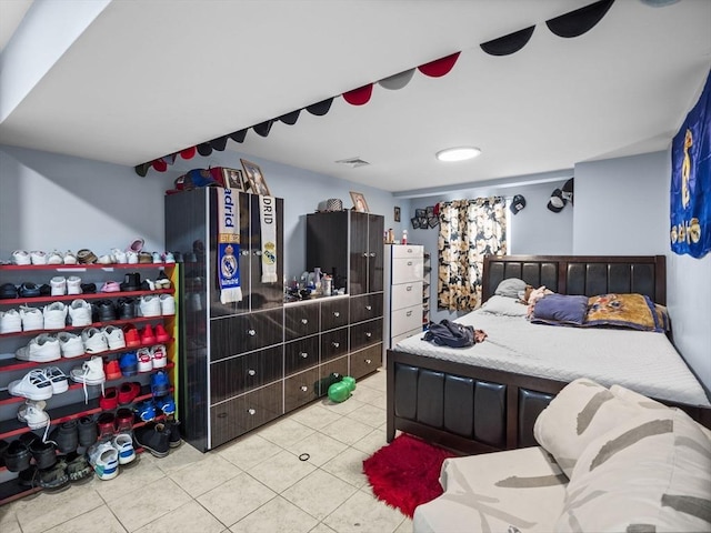 bedroom featuring light tile patterned floors and visible vents