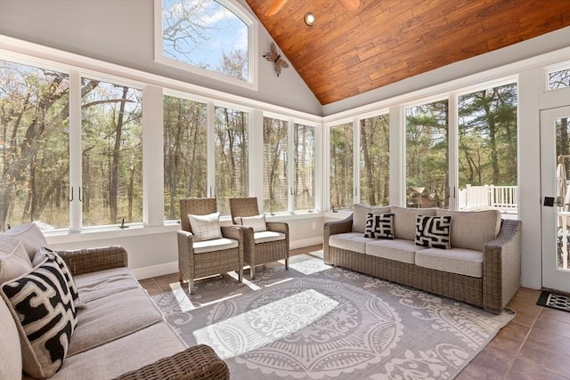 sunroom with tile patterned floors, plenty of natural light, wood ceiling, and an outdoor hangout area