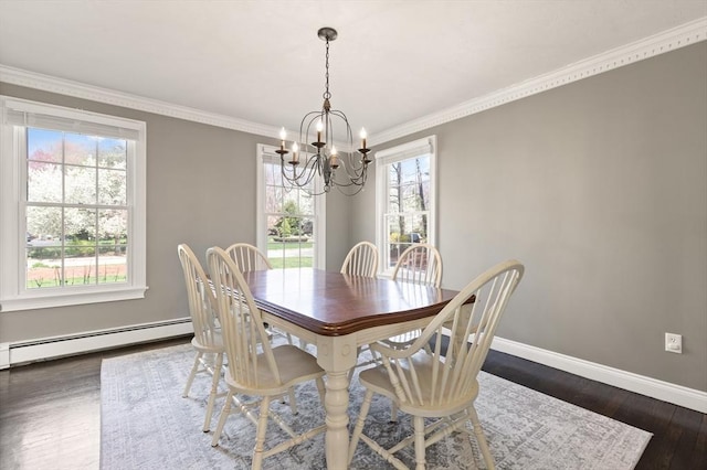 dining space featuring a notable chandelier, baseboard heating, dark wood finished floors, baseboards, and ornamental molding