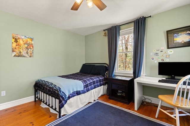 bedroom with baseboards, ceiling fan, and wood finished floors
