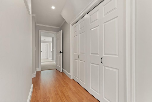hall with crown molding, baseboards, recessed lighting, and light wood-style flooring