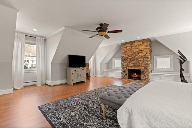 bedroom with ceiling fan, baseboard heating, wood finished floors, baseboards, and recessed lighting