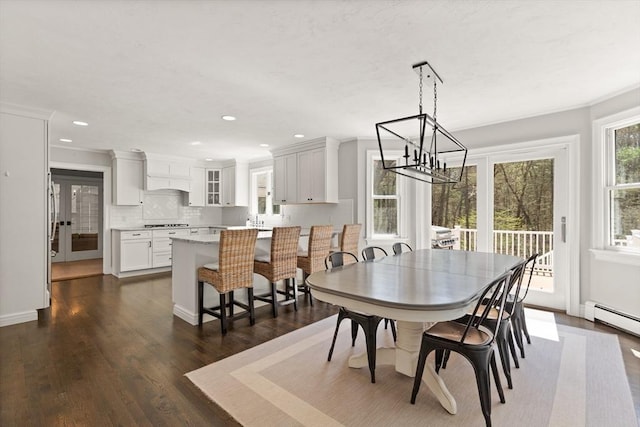 dining area featuring an inviting chandelier, crown molding, dark wood-style floors, recessed lighting, and a baseboard radiator