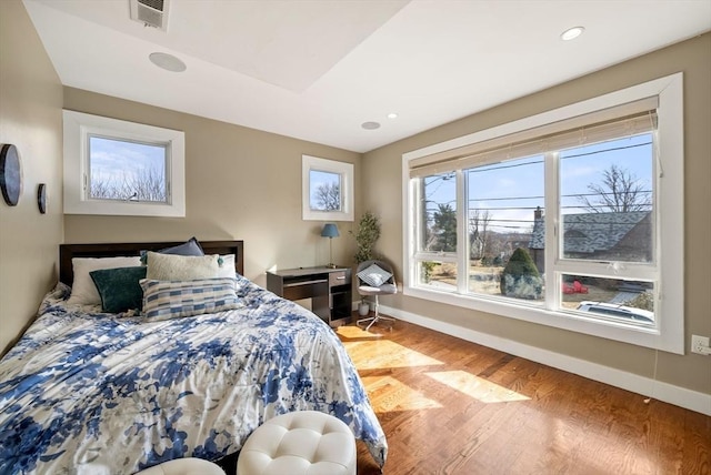 bedroom featuring recessed lighting, visible vents, baseboards, and wood finished floors