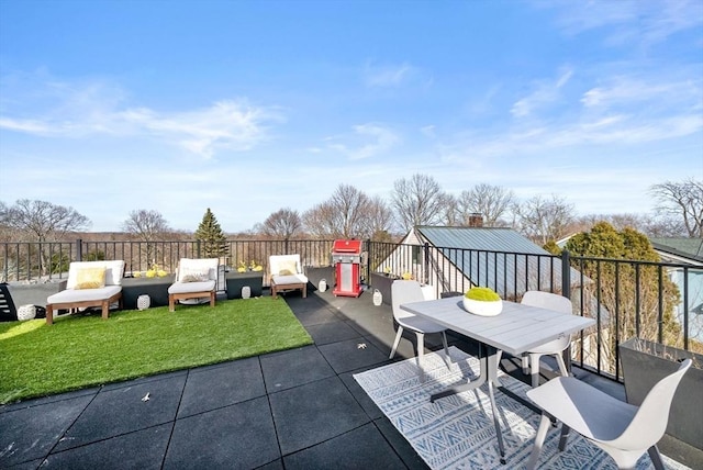 view of patio featuring outdoor dining space, fence, and an outdoor hangout area