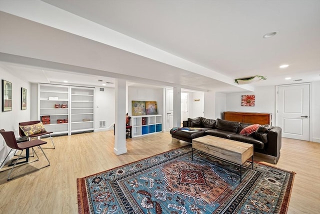 living area with recessed lighting, built in features, wood finished floors, and visible vents