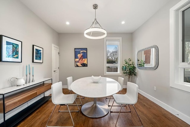 dining room featuring dark wood-type flooring, recessed lighting, and baseboards