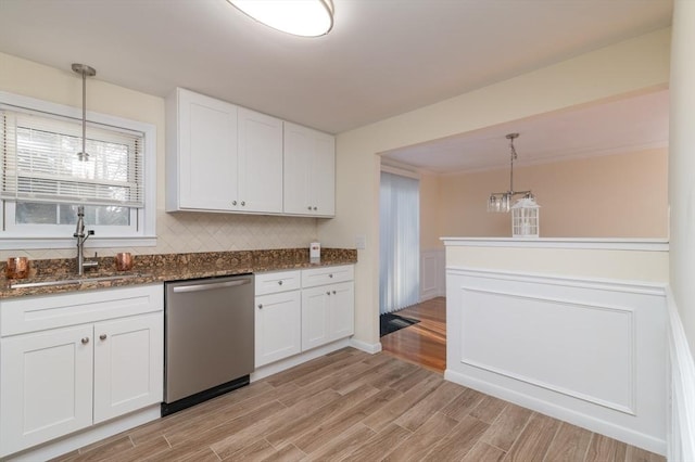 kitchen featuring pendant lighting, stainless steel dishwasher, and white cabinets