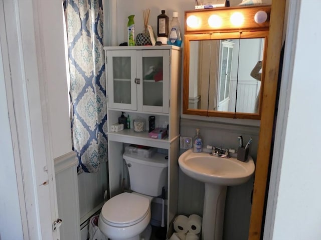 bathroom featuring toilet and baseboard heating