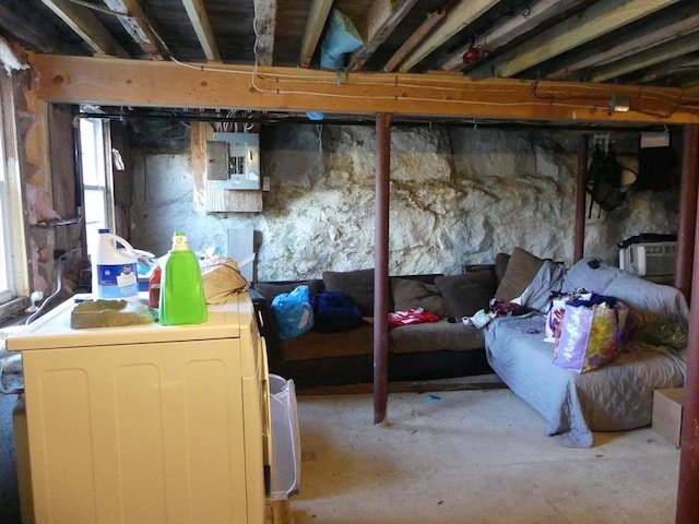 basement featuring separate washer and dryer and electric panel