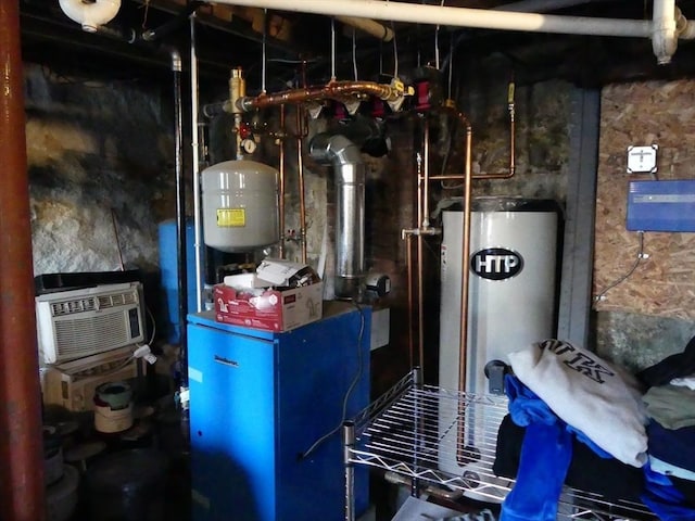 utilities with gas water heater and an AC wall unit