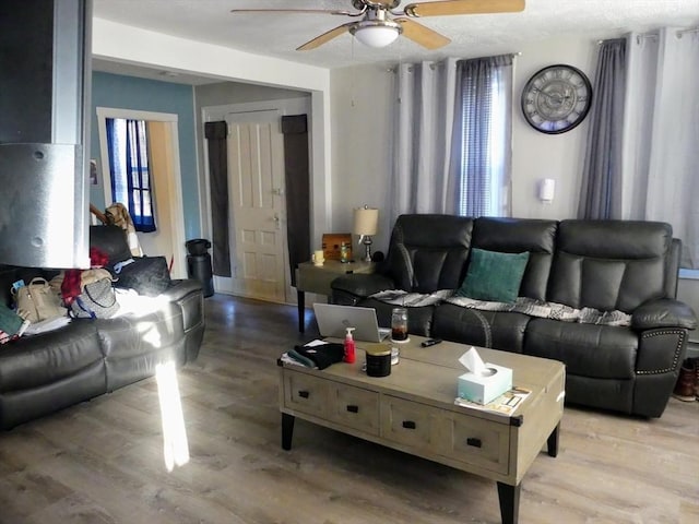 living room featuring ceiling fan and wood-type flooring