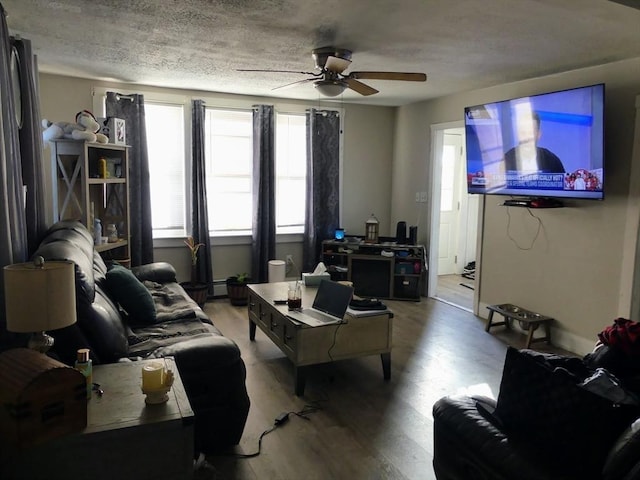 living room featuring ceiling fan, a textured ceiling, and hardwood / wood-style flooring