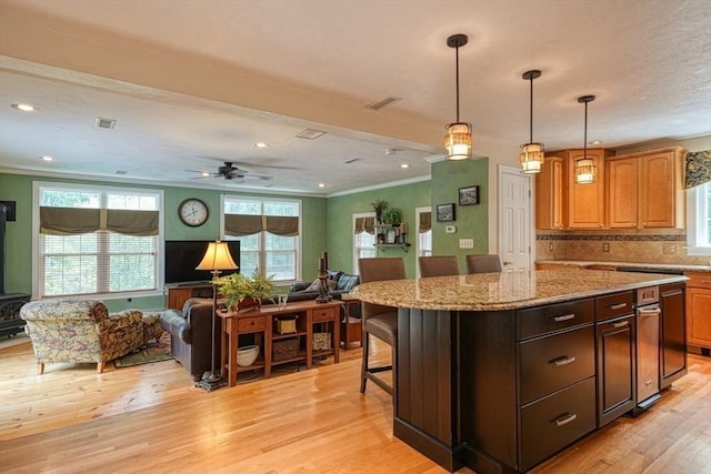 59 Davis St, Northborough, MA 01532 - kitchen featuring open floor plan, crown molding, plenty of natural light, light wood-style floors, and a center island