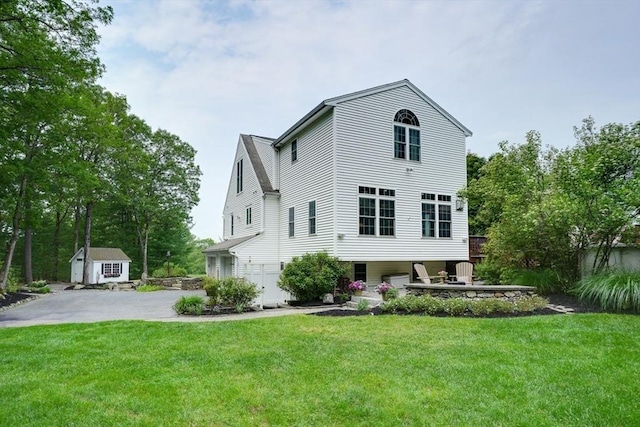 59 Davis St, Northborough, MA 01532 - rear view of house with a lawn, an outdoor structure, and asphalt driveway