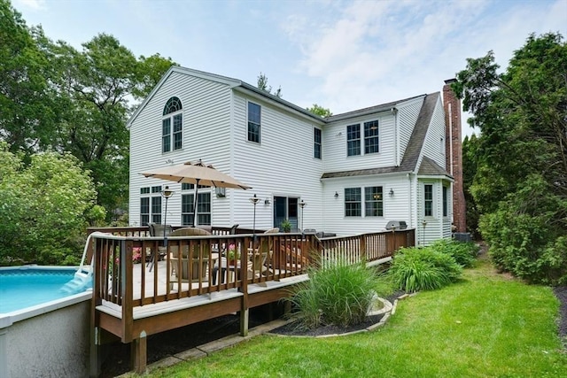 59 Davis St, Northborough, MA 01532 - rear view of property featuring a chimney, an outdoor pool, a deck, and a yard