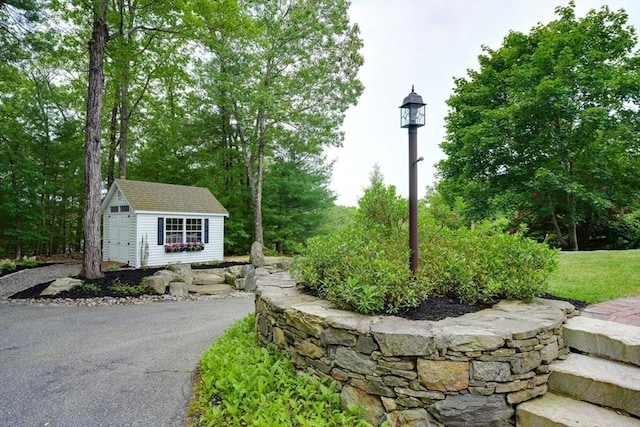 59 Davis St, Northborough, MA 01532 - view of asphalt driveway featuring street lighting