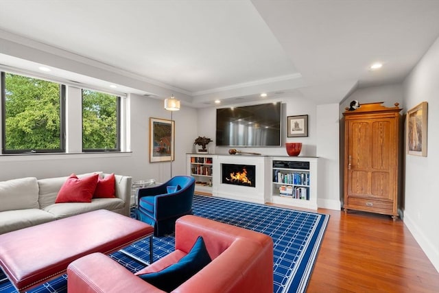 134 Mount Auburn St Unit 7, Watertown, MA 02472 - living room featuring wood finished floors, recessed lighting, a warm lit fireplace, baseboards, and ornamental molding